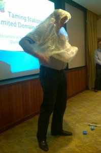 MD of Optima Systems models a rain poncho