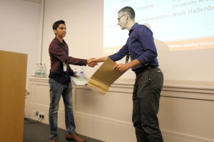 Joshua David receives his certificate from Niels Hallenberg